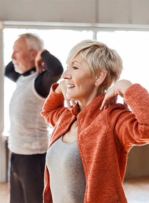 An older couple stretching.